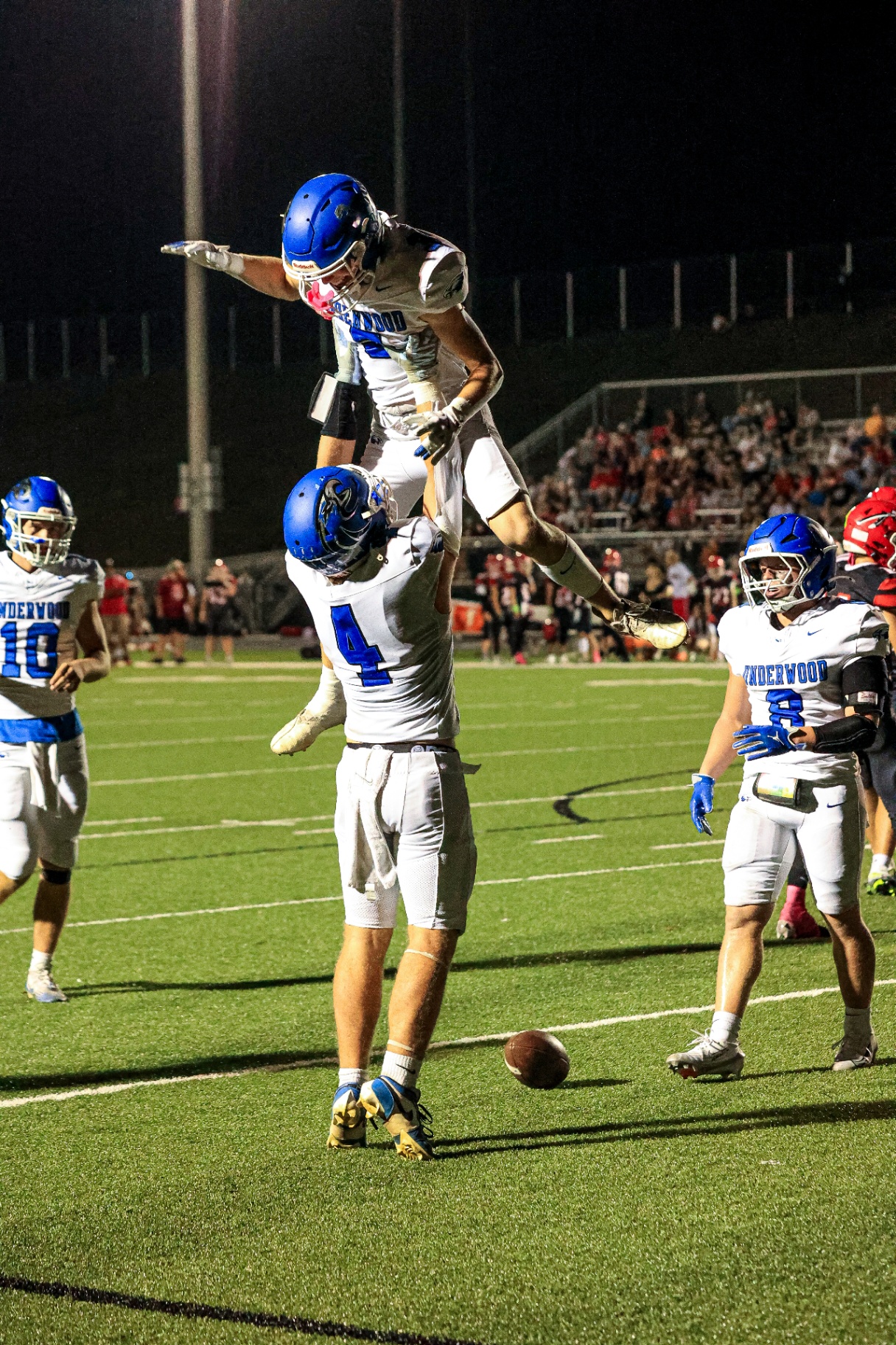 Underwood Eagles touchdown celebration under stadium lights